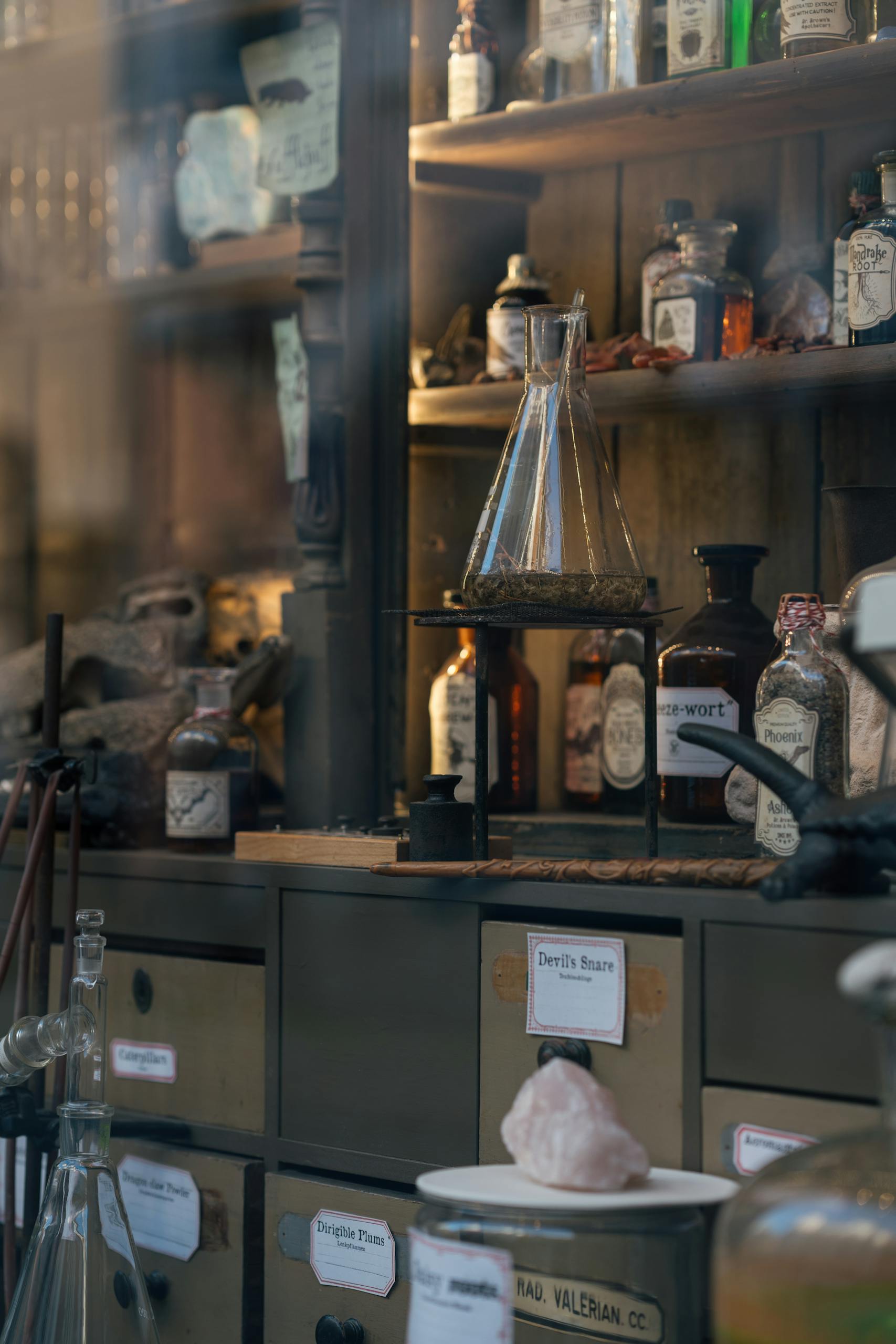 Charming vintage apothecary shop display with bottles and retorts in Lübeck, Germany.